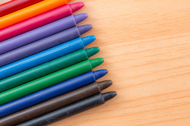 istock crayon colors on wood background with copy space 823672548