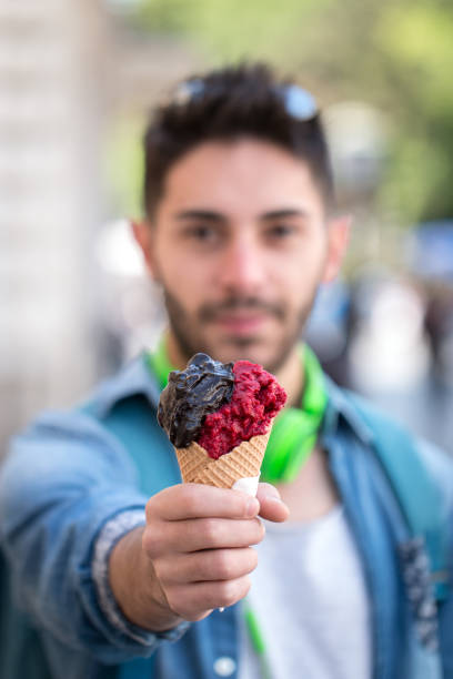istock Young Adult Man Eating Ice-Cream. 823673032