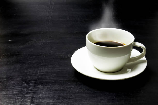 istock Cup of coffee on a wooden table 823673072