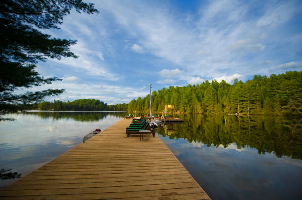 istock Cottage life - Lounge chairs on a wood dock 823673092