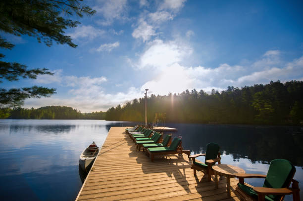 istock Cottage life - Chairs on a dock during sunrise 823673160