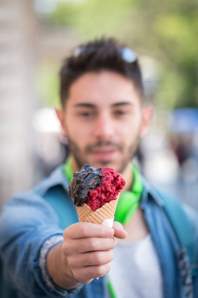 istock Young Adult Man Eating Ice-Cream. 823673210