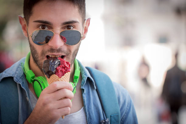 istock Young Adult Man Eating Ice-Cream. 823676286
