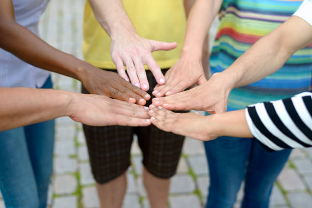 istock Group of people touching hands in a circle 823686630