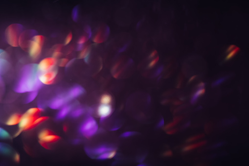 Abstract blur light bokeh, purple and red. Blurred glittering shine , night background. Christmas wallpaper decorations concept. New year holiday festive backdrop. Sparkle circle celebrations display.
