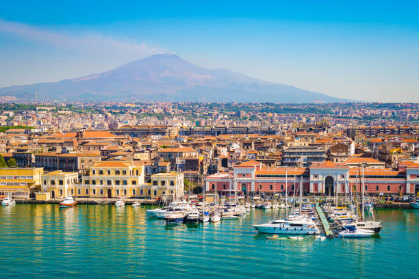 Catania Sicily, Italy Beautiful view of Catania cruise port with smoking volcano Etna in the background. mt etna stock pictures, royalty-free photos & images