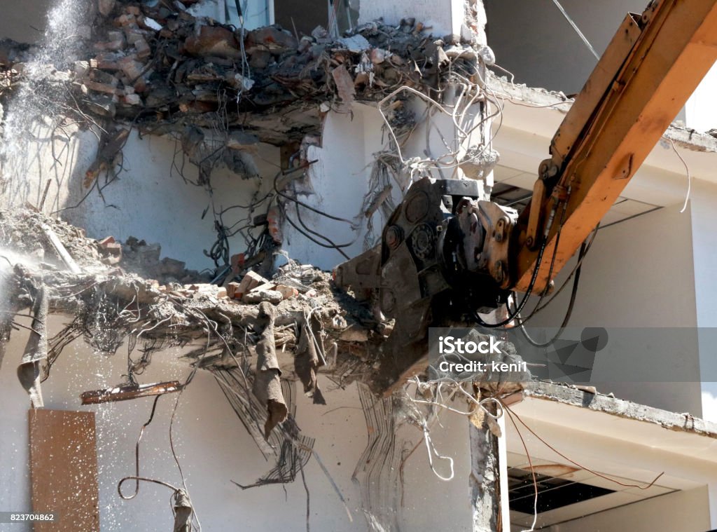 Building demolition machine Demolition of a building with concrete floors and pillars. Abandoned Stock Photo