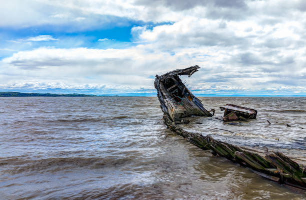 istock Baie-Saint-Paul in Quebec, Canada shipwreck in water with waves 823705616