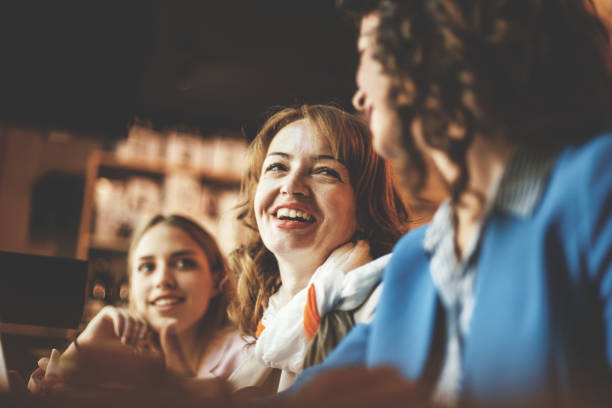 istock Female friends smiling in cafe 823707646