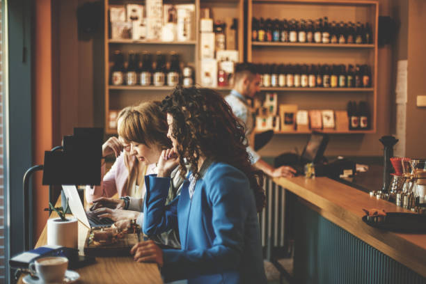 istock Women using laptop in cafe bar together 823707652