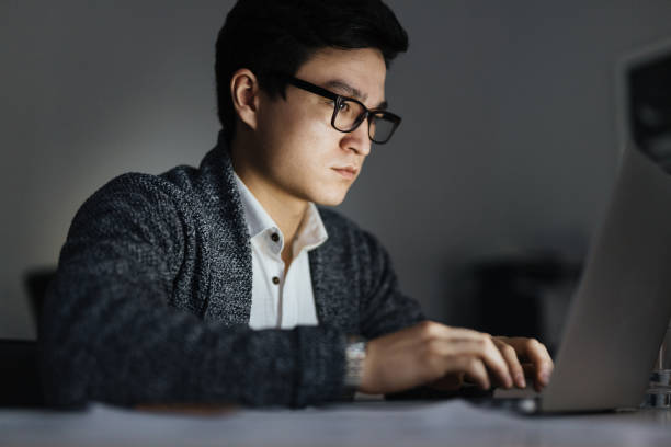 istock Asian Man Working with Laptop at Night 823708542