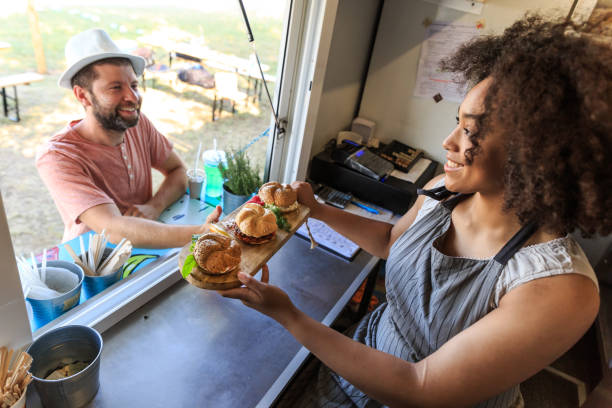 istock Food van chef serving sandwiches to customer 823708654