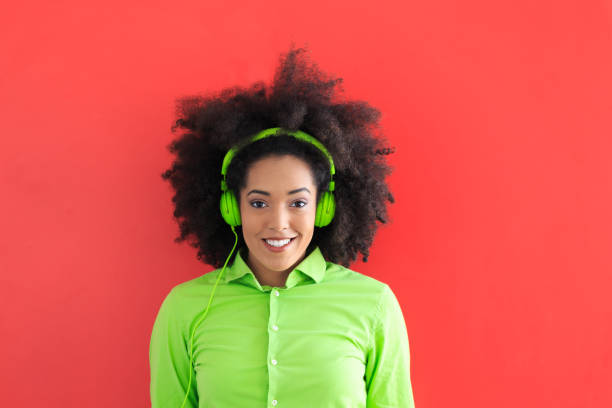 istock Afro woman with green headphones 823708678