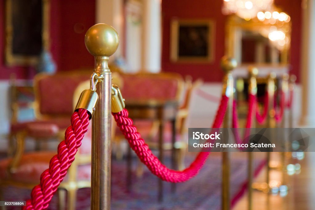 Detail of red rope on a exhibition space - defocused background concept image Museum Stock Photo