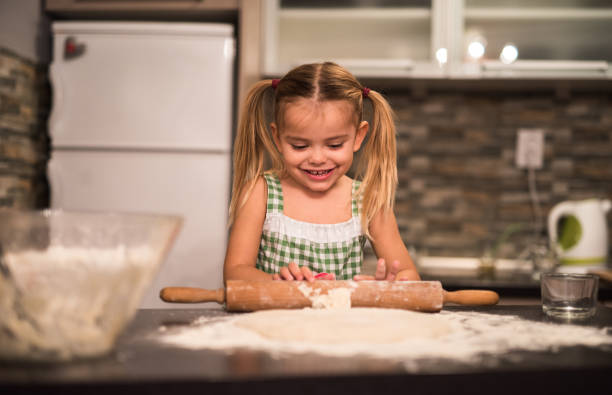 istock Cute little girl having fun while baking in the kitchen. 823708830