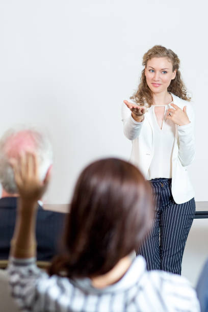 istock Smiling Female Speaker Giving Floor to Audience 823709244