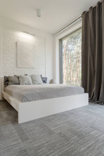 istock Cosy bedroom with bed huge window 823709870