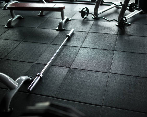 istock Barbell on the floor in the empty gym 823709960
