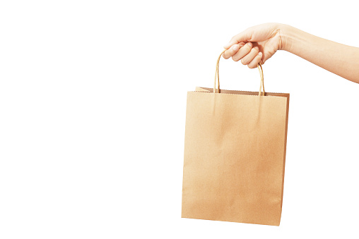 woman hand hold paper shopping bag