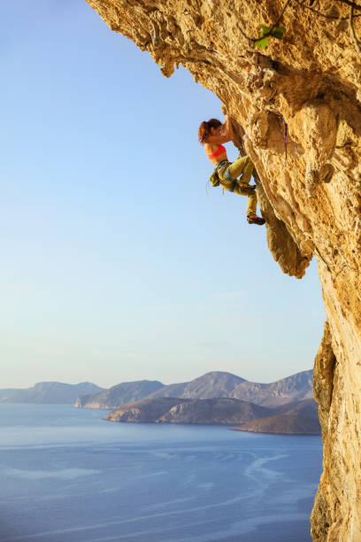 istock Female rock climber on challenging route on cliff 823713358