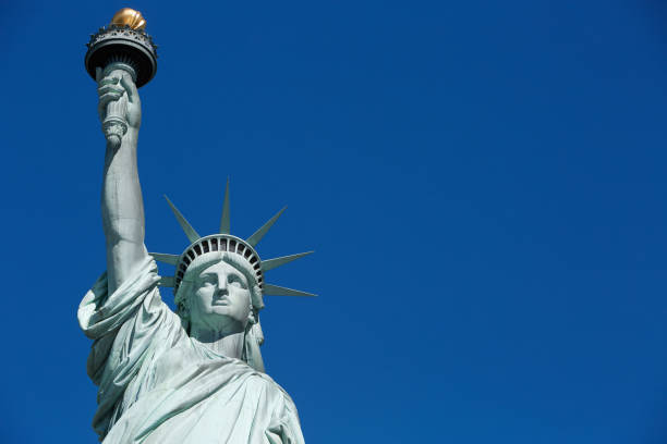 istock Statue of Liberty upper part with blank blue sky space 823716064