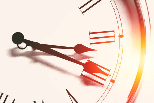istock clock time roman hour number vintage color tone with light effect for background. 823721988