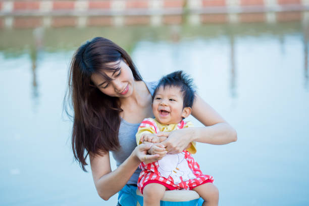 istock Young mother with her little son in summer park 823726524