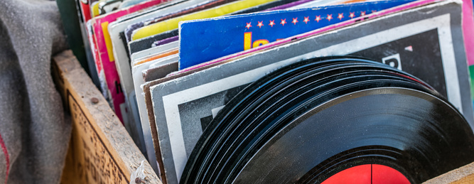 display of old LPs and vintage vinyls for music collectors and collections at garage sale of flea market, outdoors