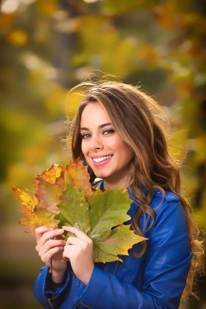 istock Girl hiding behind the leafs in the nature. 823733088