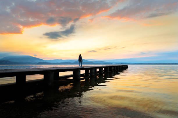 Sunrise - woman on wooden jetty