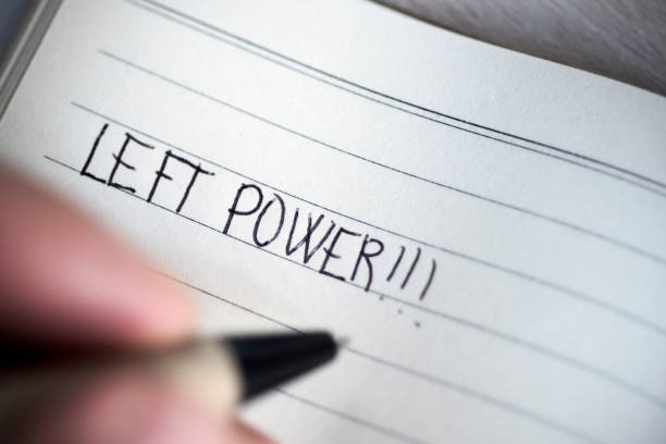 istock left-handed man handwriting the text left power 823736798
