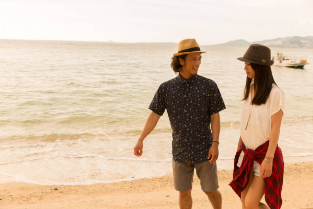 istock A couple walks on a sandy beach. 823737844