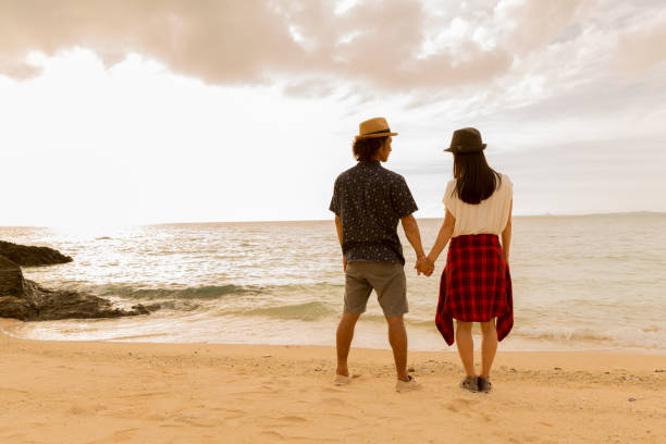 istock A couple walks on a sandy beach. 823737942