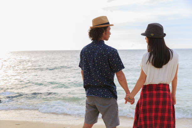 istock A couple walks on a sandy beach. 823737950