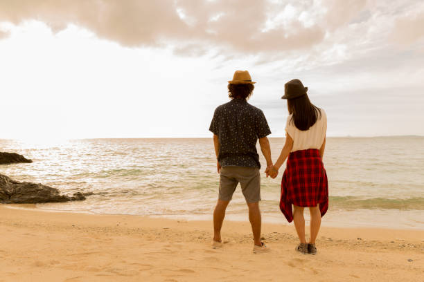istock A couple walks on a sandy beach. 823737956