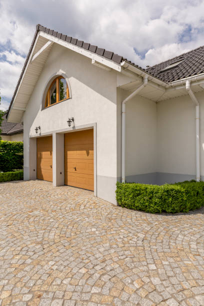 Modern and well-designed Paving stone driveway and two garages in detached house exterior garage door opener photos stock pictures, royalty-free photos & images
