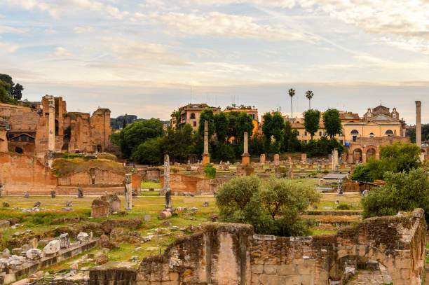 istock Roman Forum in the evening, a rectangular forum surrounded by the ruins of several important ancient government buildings at the center of the city of Rome. 823741556