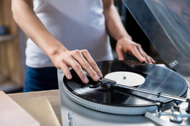 istock Cropped, close-up image of woman using vinyl audio player 823743920
