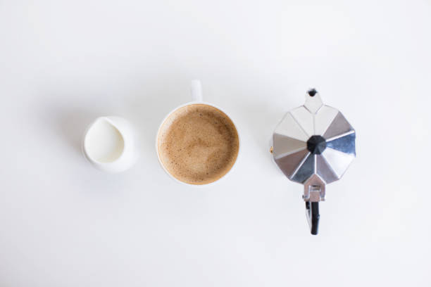 top view of french press, cup of coffee and milk jar standing in row top view of french press, cup of coffee and milk jar standing in row, isolated on white coffee pot stock pictures, royalty-free photos & images