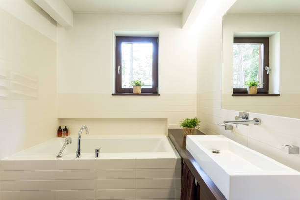 istock Modern white bathroom with tiled bathtub 823752028