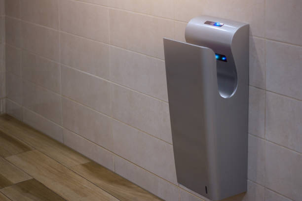 istock Modern vertical hand dryer in public restroom WC 823758710