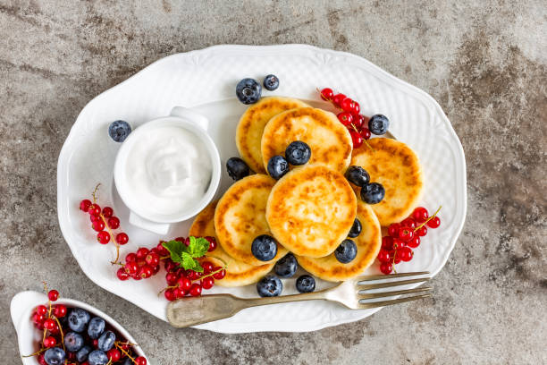 istock Cottage cheese fritters, pancakes with berries 823764434