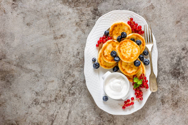 istock Cottage cheese fritters, pancakes with berries 823764620
