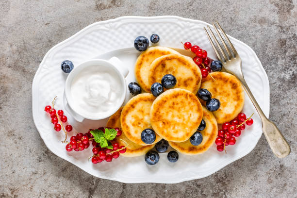 istock Cottage cheese fritters, pancakes with berries 823764622