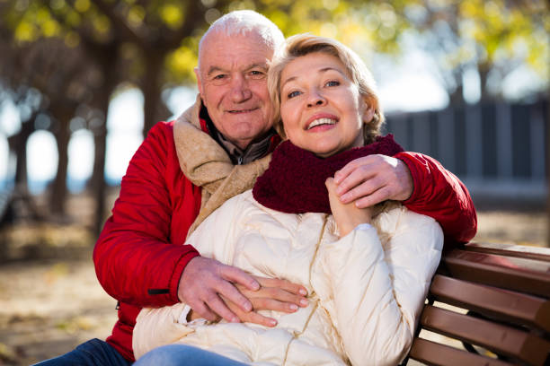 istock Mature couple sitting in park 823767218