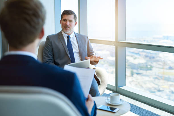 istock Mature businessman holing an interview with young applicant 823767250