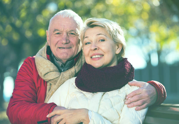 istock Mature couple sitting in park 823767270