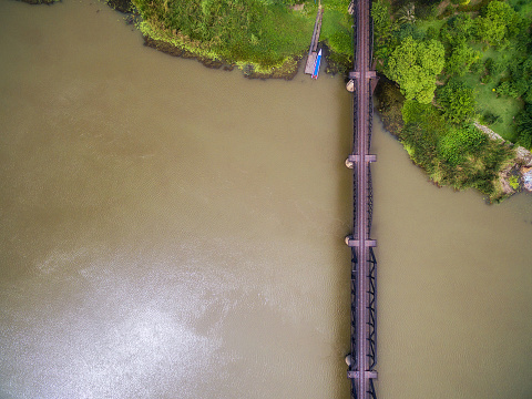 Aerial view of steel railway bridge over Kwai river in Kanchanaburi, Thailand.
