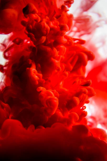 istock red ink in water isolated on white background 823774598