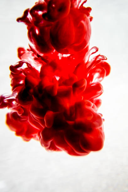 istock red ink in water isolated on white background 823774852